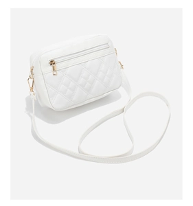 Detail view of white quilted crossbody bag with dual golden zippers and classic lattice pattern