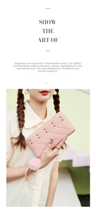 Detail of pink quilted leather wallet with gold studs, pompom charm and wristlet strap