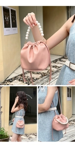 Detailed macro of pink lychee pattern bucket bag with pearl handle and drawstring