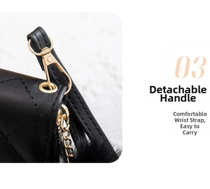 Detail of black quilted leather wallet with gold metal buckle and detachable wrist strap