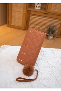 Brown long wallet with diamond stitching, gold studs, and soft plush pom-pom charm detail