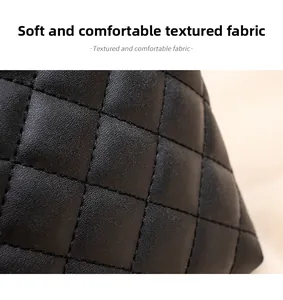 Macro shot of black quilted tote bag showing soft leather texture and diamond stitching