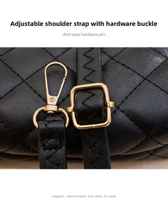 Detail of black quilted tote with adjustable strap and shiny gold metal hardware