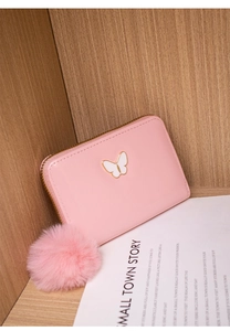 Close-up of pink PU leather wallet with a white butterfly logo and plush pompom charm