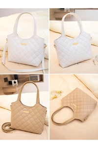 Close-up of quilted diamond pattern and metallic accents on dual-color tote bags