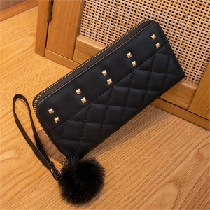 Black quilted faux leather long clutch wallet with gold studs and pompom charm decoration