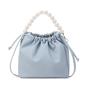 Light blue lychee textured leather bucket bag with white pearl handle and drawstring