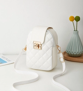 Detail of white quilted crossbody phone bag with elegant gold metal twist lock