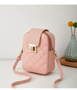 Detailed view of pink quilted phone crossbody bag featuring a golden metal twist lock clasp