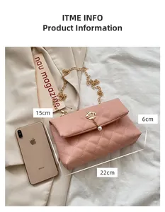 Pink quilted shoulder bag with gold crown pendant and chain strap on light fabric