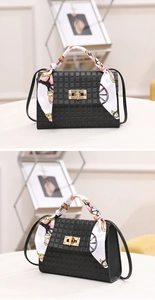 Detail of black lattice embossed mini handbag with silk scarf and gold twist lock clasp