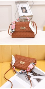 Brown checkered handbag featuring a silk scarf-wrapped handle and golden twist lock