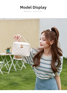 Close-up of cream quilted cosmetic bag with top handle and dual metal zippers outdoors