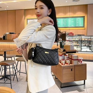 Borsa a tracolla trapuntata nera alla moda con portamonete su una modella elegante