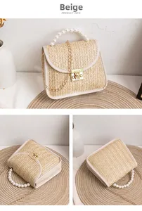 Close-up of woven straw bag with faux pearl handle and gold chain detail in pink