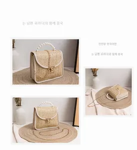 Detailed view of woven straw bag with pearl handle and golden chain strap for summer