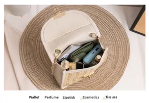 Detailed interior of woven crossbody bag showing storage for phone and cosmetics