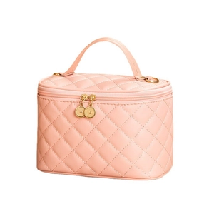 Pink quilted leather bucket bag with top handle and gold zipper in a front 45-degree view