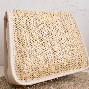 Mini woven straw crossbody bag with pearl handle and golden chain strap in beige