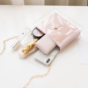 Women's transparent PVC crossbody bag with pink inner pouch and gold chain strap