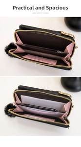 Detail of black crossbody wallet interior showing card slots and pink lining contrast