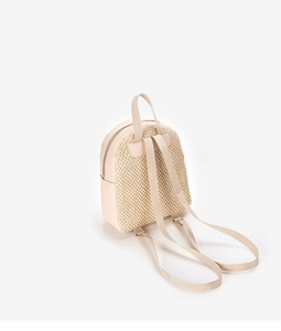 Detail view of beige woven straw backpack with smooth leather trim and metal zipper