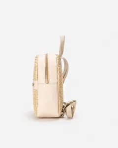 Side view of beige woven backpack featuring faux leather panels and adjustable straps