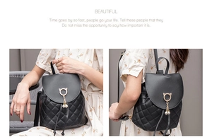 Close-up of quilted leather backpack featuring gold cat hardware and pearl tassel detail