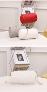Detail view of mini cylinder bags with quilted pattern and gold metal chain straps