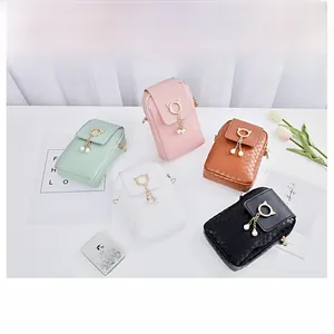 Detailed view of colorful quilted mini bags with cat-shaped gold buckle and pearl tassels