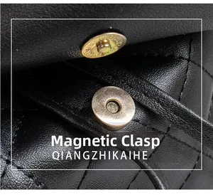 Detailed macro view of the metal magnetic snap closure on a black quilted leather bag
