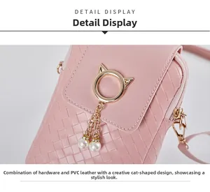 Close-up of pink woven crossbody bag featuring a gold cat clasp and white pearl tassel