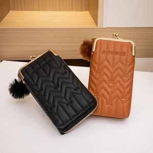 Quilted leather crossbody cell phone bag in black and brown with metal clasp and pompom