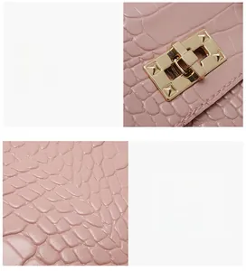 Detail of pink crocodile embossed leather with gold metal twist lock on the handbag