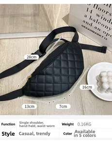 Detailed view of black quilted waist bag with golden zipper on a wooden floor background