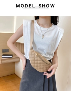 Khaki quilted waist bag with adjustable strap and gold zipper shown on model