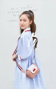 Pink and white crossbody bag with 3D cherry charm and striped shoulder strap