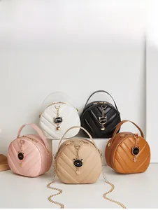 Close-up of mini quilted handbags in five colors featuring cat-shaped metal charms
