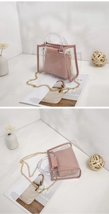 Pink transparent PVC tote bag detail with matching inner pouch and gold chain strap