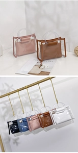 Close-up of stylish 2-piece PVC tote bag set with clear handle and inner PU pouch