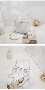 Detailed view of white transparent PVC tote with round handles and gold chain strap