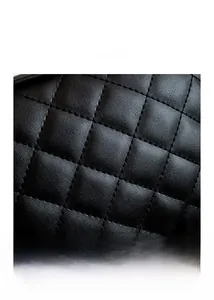 Close-up of black quilted leather texture and precision stitching on the shoulder bag