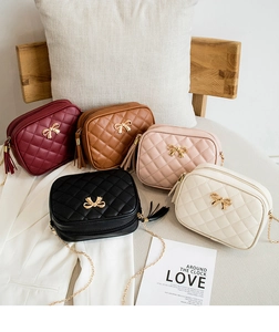 Group shot of mini quilted camera bags with gold chain straps and tassel zipper pulls