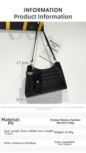 Detail of black stone-pattern shoulder bag with small charm pouch and gold-tone hardware