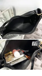 Detailed view of the black crocodile pattern bag interior showing large capacity storage