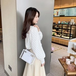 Chic white transparent PVC bucket bag with chain strap and inner pouch shown on a model