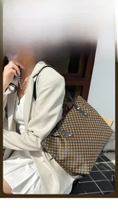 Detailed view of polka dot tote bag with long straps and metal rivet accents