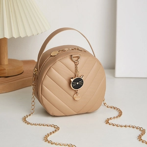 Beige quilted mini crossbody bag with gold chain strap and cute black cat charm