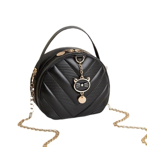 Black round crossbody bag with V-quilted texture and cat-shaped gold pendant charm