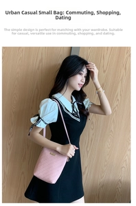 Detailed view of pink crossbody bucket bag with textured pattern and gold logo plaque
